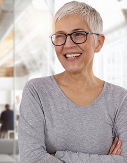 older woman crossing her arms and smiling 