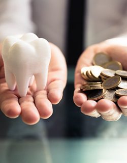 Tooth balances with a pile of coins