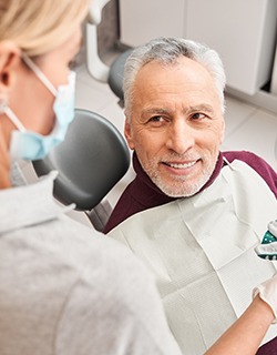 A dentist presenting her patient with dental impressions for dentures