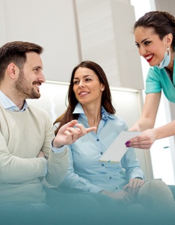 A couple waiting in the lobby while talking with a dental professional about financing options for dental implants in Mount Pleasant