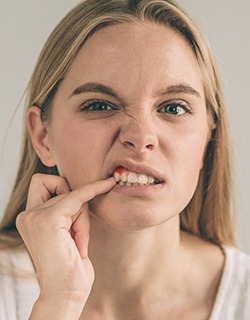 woman pointing to gums