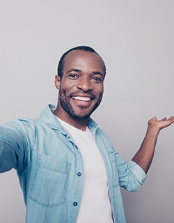 smiling man who is enjoying the benefits of smile makeovers in Mount Pleasant