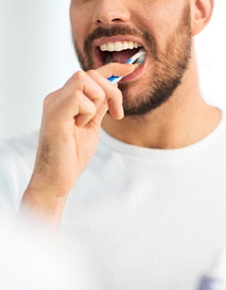 man brushing teeth after teeth whitening in Mount Pleasant