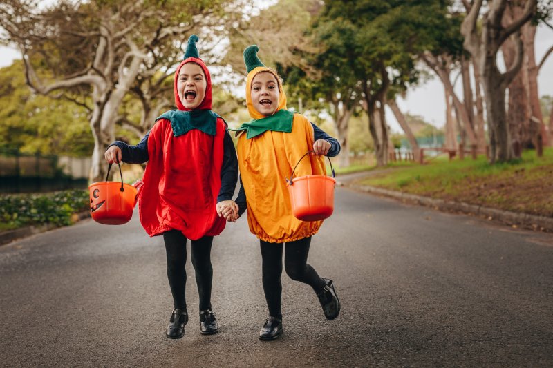 Children walking in costumes after practicing Halloween oral health tips
