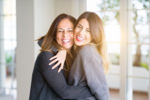 mother and daughter smiling and hugging
