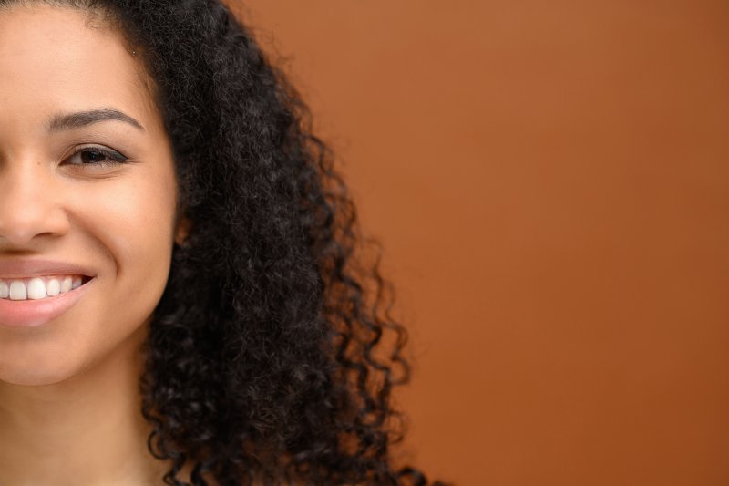 A woman smiling after her smile makeover