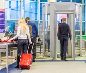 a person walking through an airport metal detector